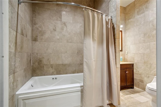 full bathroom with tile walls, toilet, vanity, shower / tub combo with curtain, and tile patterned flooring