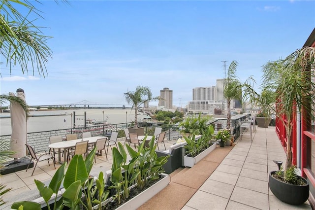 view of patio featuring a water view and a balcony