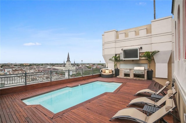 view of pool with exterior kitchen