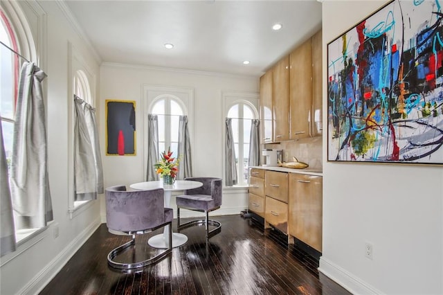 dining space featuring crown molding and dark hardwood / wood-style flooring