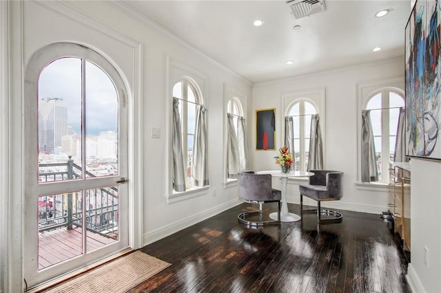 foyer entrance featuring crown molding, hardwood / wood-style flooring, and plenty of natural light