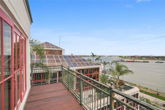 wooden terrace featuring a water view