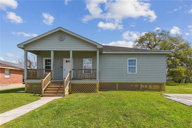 view of front of home with covered porch and a front lawn