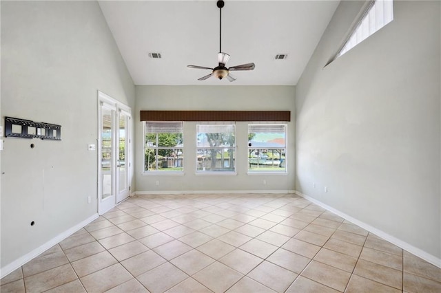 tiled spare room featuring high vaulted ceiling and ceiling fan