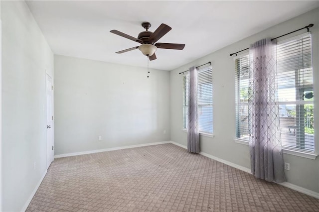 spare room featuring ceiling fan and light colored carpet