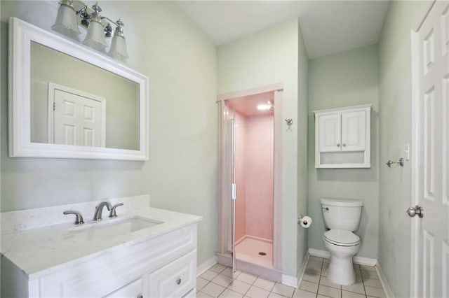 bathroom featuring toilet, vanity, a shower, and tile patterned flooring