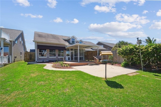 back of property with a yard and a patio area