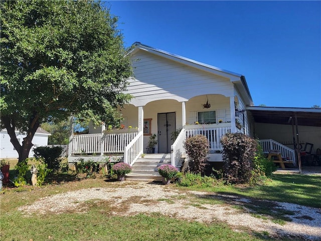 view of front of property with covered porch and a front yard