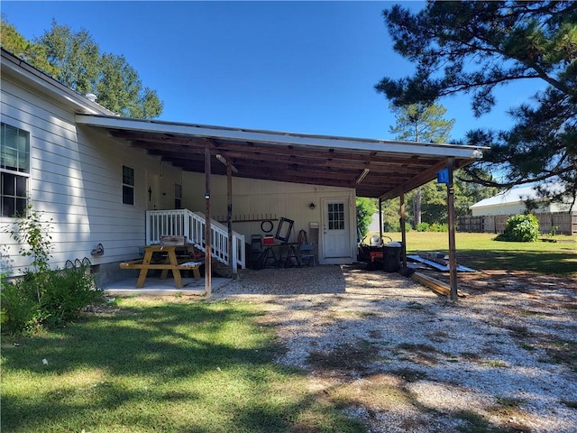 view of car parking with a yard and a carport