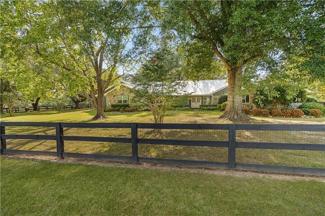 view of gate with fence and a yard