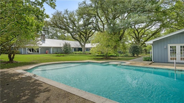 view of pool with a yard