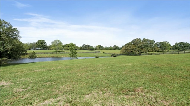 view of yard with a water view and a rural view