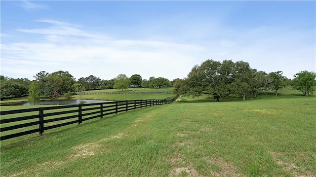 view of yard featuring a water view and a rural view