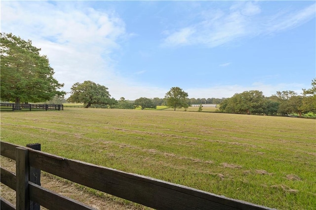 view of yard featuring a rural view and fence