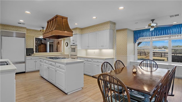 kitchen featuring light hardwood / wood-style floors, white cabinetry, and a center island