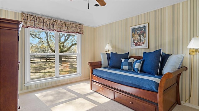 living area with ceiling fan, carpet flooring, and plenty of natural light