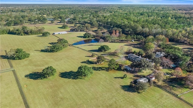 birds eye view of property featuring a water view and a rural view