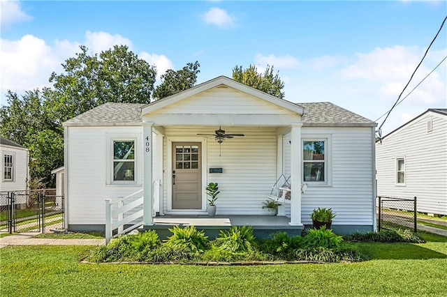 bungalow featuring ceiling fan and a front lawn