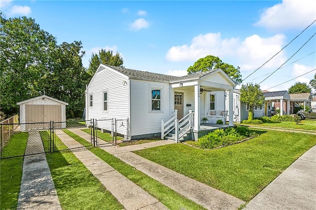 bungalow-style house featuring a shed, a front yard, and a porch