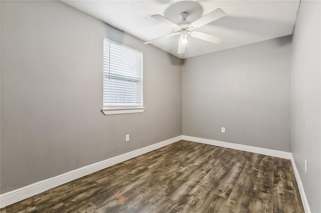 spare room with dark hardwood / wood-style floors and ceiling fan