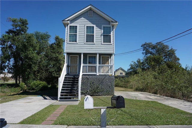 view of front facade with covered porch and a front lawn