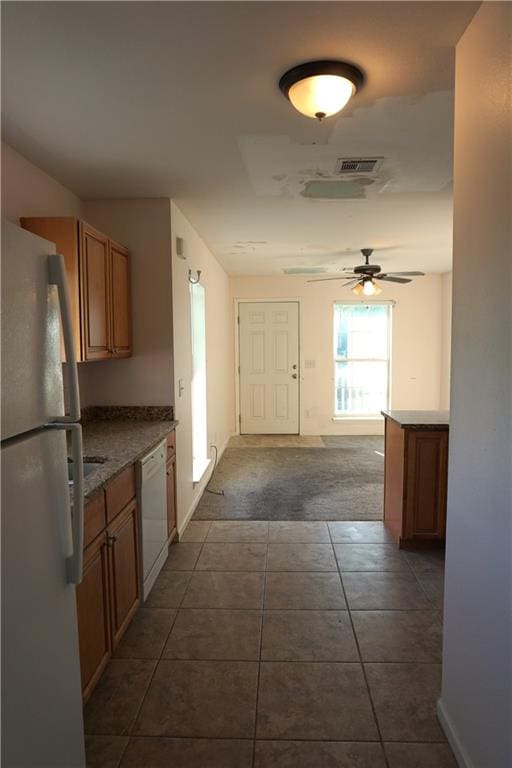 kitchen featuring dishwasher, dark colored carpet, fridge, and ceiling fan