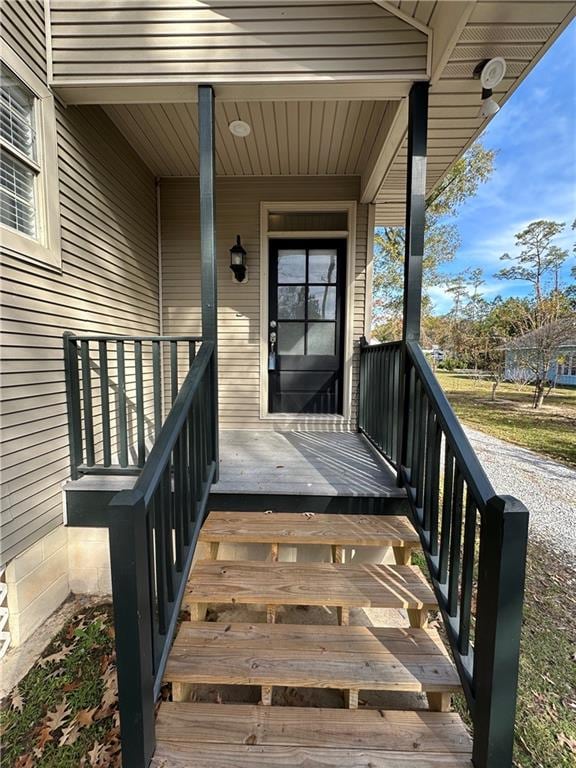 view of exterior entry with a porch