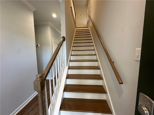 stairway with hardwood / wood-style flooring and ornamental molding