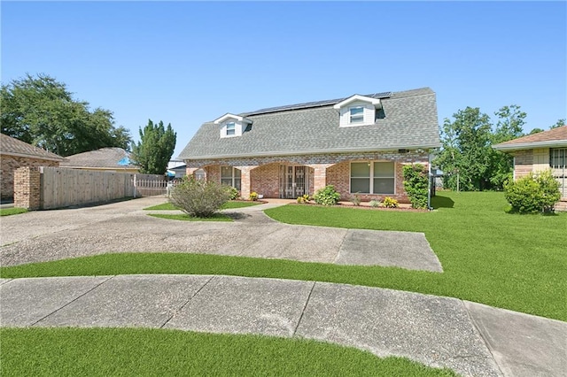 cape cod home with a front yard