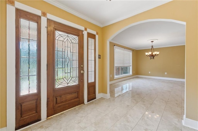 tiled entrance foyer featuring a wealth of natural light, ornamental molding, and a chandelier