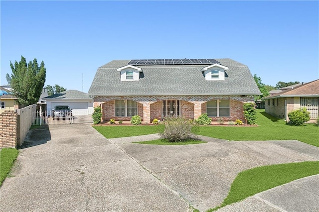 view of front of house featuring solar panels, a front yard, and a garage