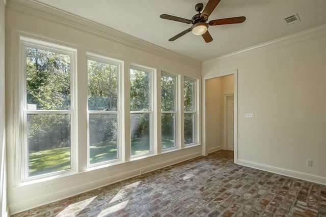 unfurnished sunroom featuring ceiling fan