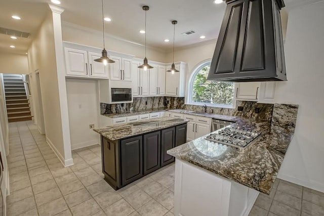kitchen featuring tasteful backsplash, white cabinets, light tile patterned flooring, and appliances with stainless steel finishes