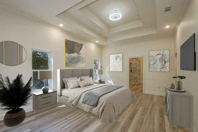 bedroom with recessed lighting, ornamental molding, light wood finished floors, visible vents, and a raised ceiling