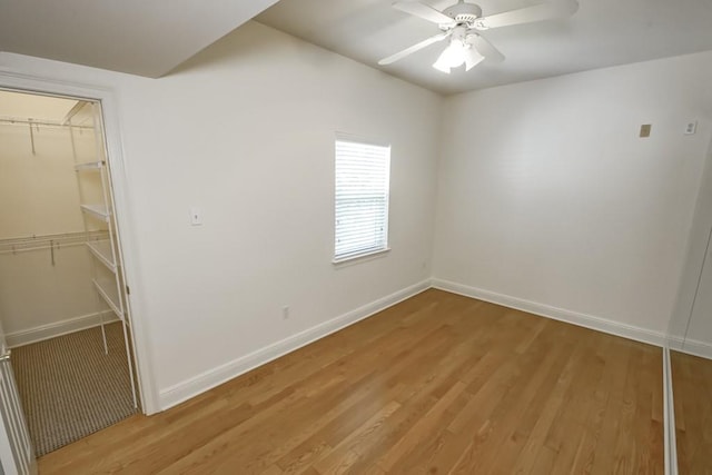 unfurnished room featuring light wood-type flooring, ceiling fan, and baseboards