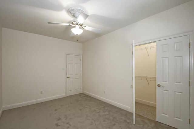 unfurnished bedroom featuring ceiling fan, carpet, and ensuite bathroom