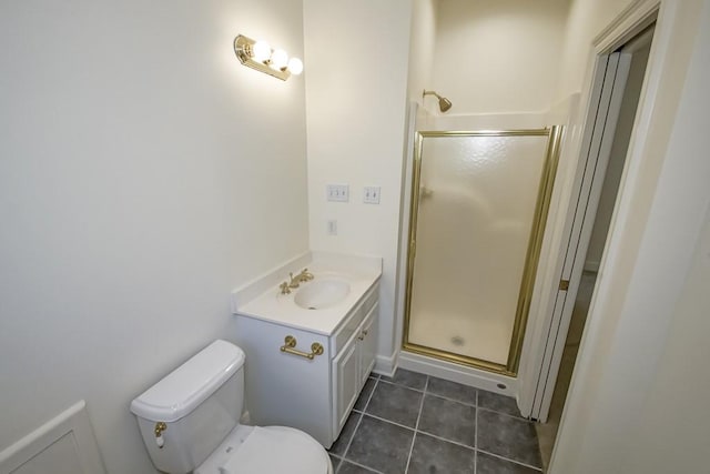 bathroom with vanity, tile patterned flooring, toilet, and walk in shower