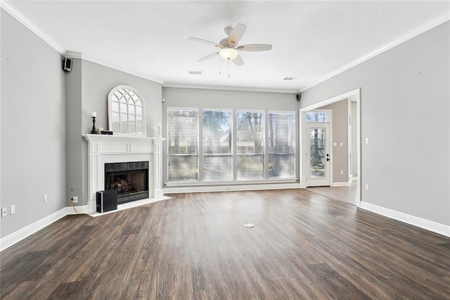 unfurnished living room featuring crown molding, dark hardwood / wood-style floors, a fireplace, and ceiling fan