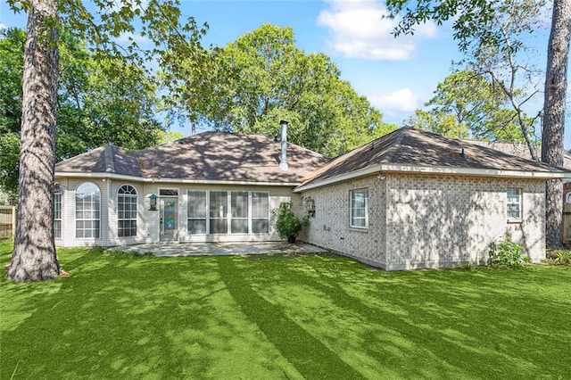 back of property with a patio and a lawn