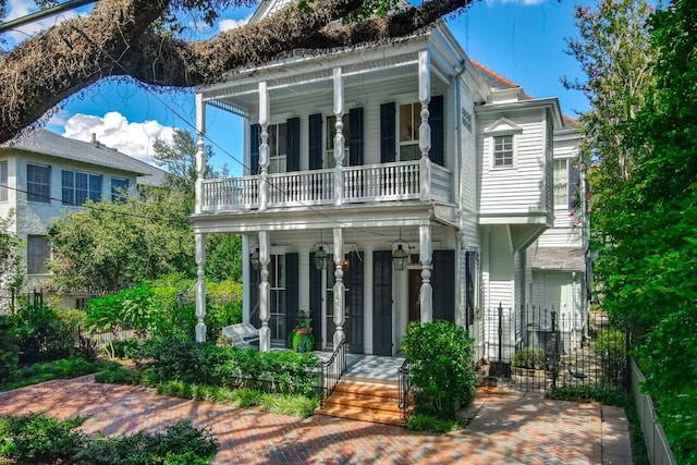 view of front of house with a porch and a balcony