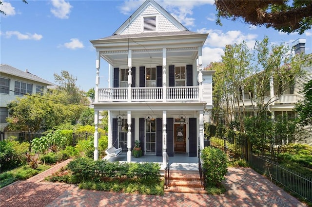 view of front of property with a balcony and covered porch