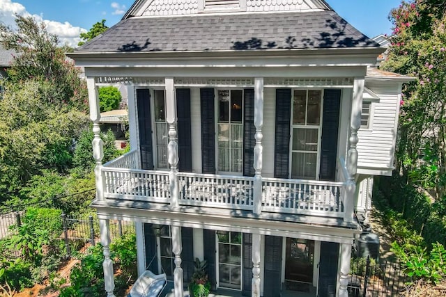 back of house featuring a balcony