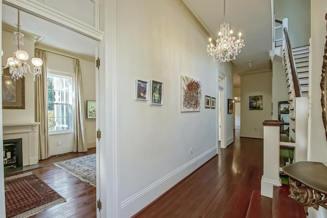 hall with a towering ceiling, an inviting chandelier, and dark hardwood / wood-style floors