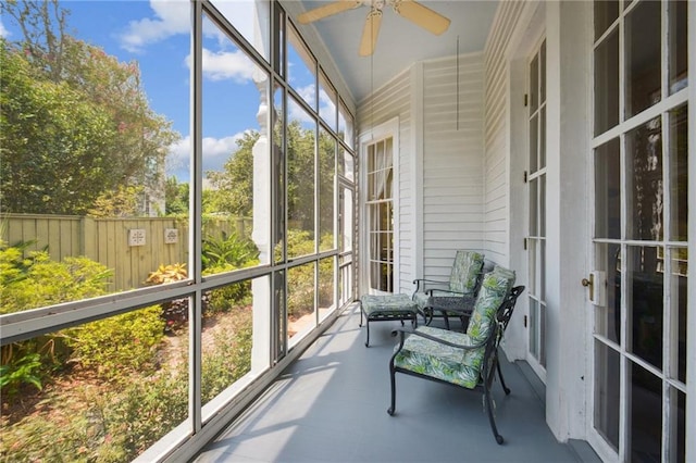 sunroom / solarium featuring ceiling fan