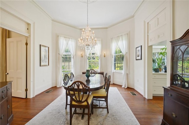 dining space featuring dark wood-type flooring and ornamental molding