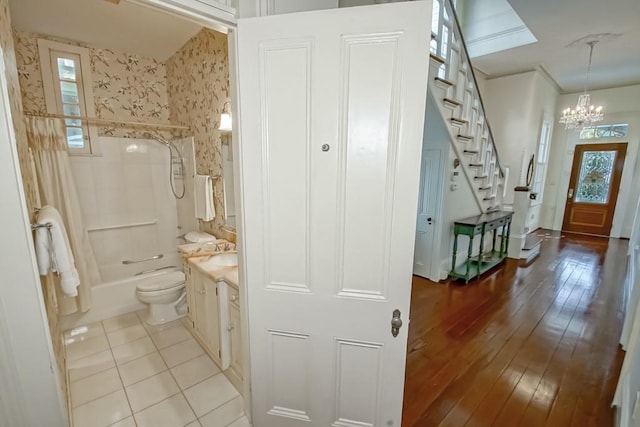 full bathroom with vanity, bathtub / shower combination, hardwood / wood-style flooring, and toilet