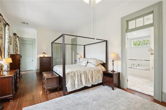 bedroom with ensuite bath, ornamental molding, and dark hardwood / wood-style floors