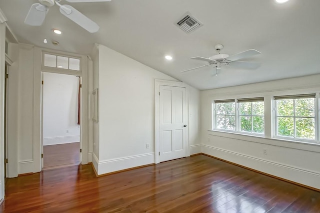 unfurnished bedroom featuring lofted ceiling, dark wood-type flooring, and ceiling fan