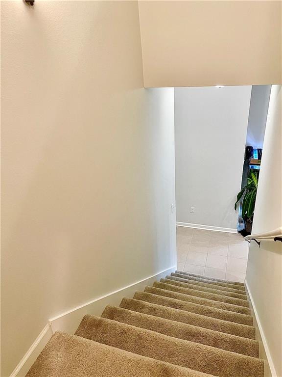 staircase with tile patterned floors