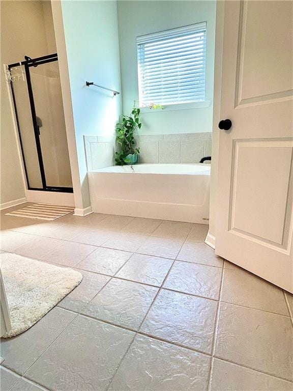 bathroom featuring plus walk in shower and tile patterned floors